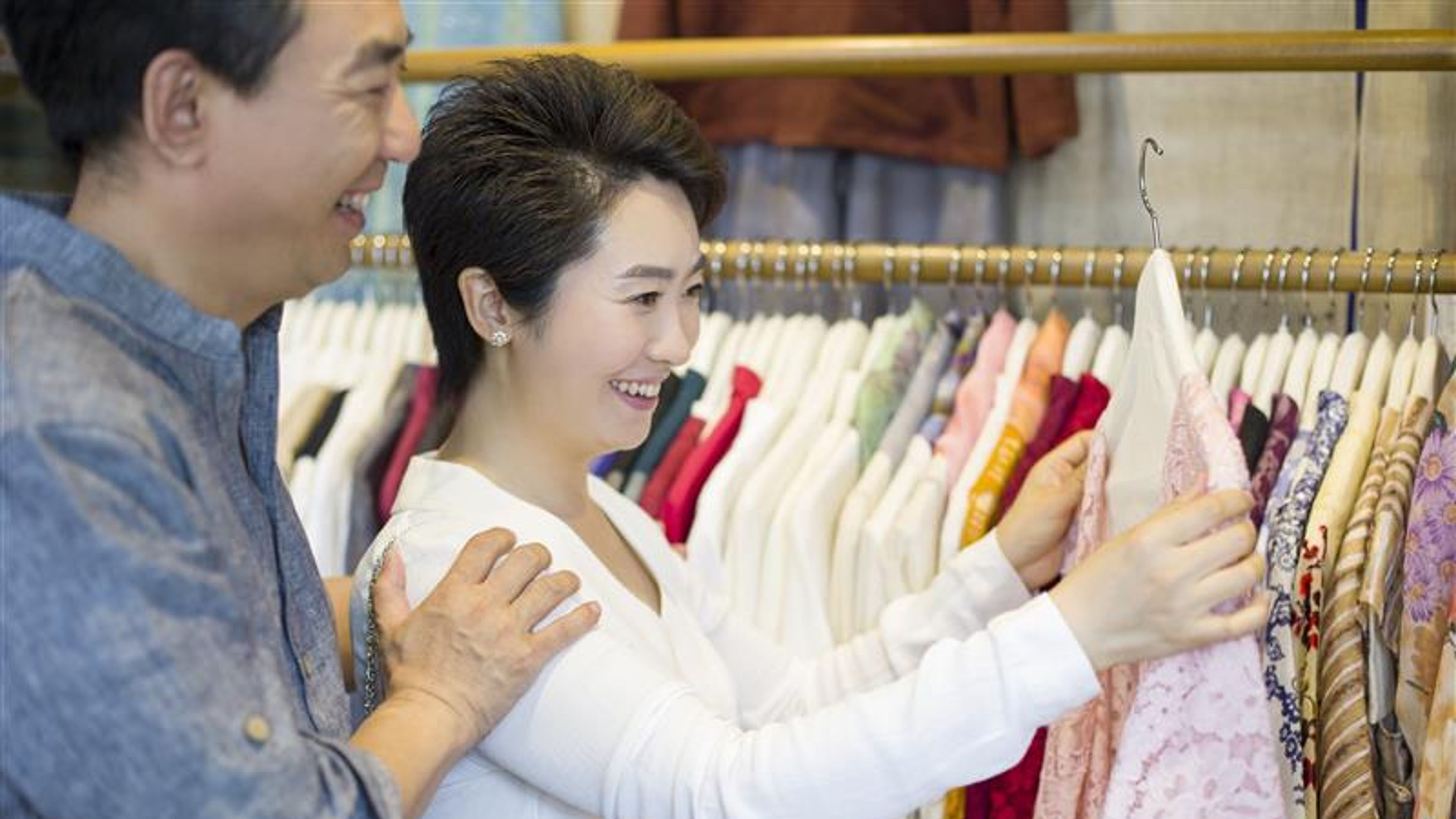 Couple shopping in clothing store.