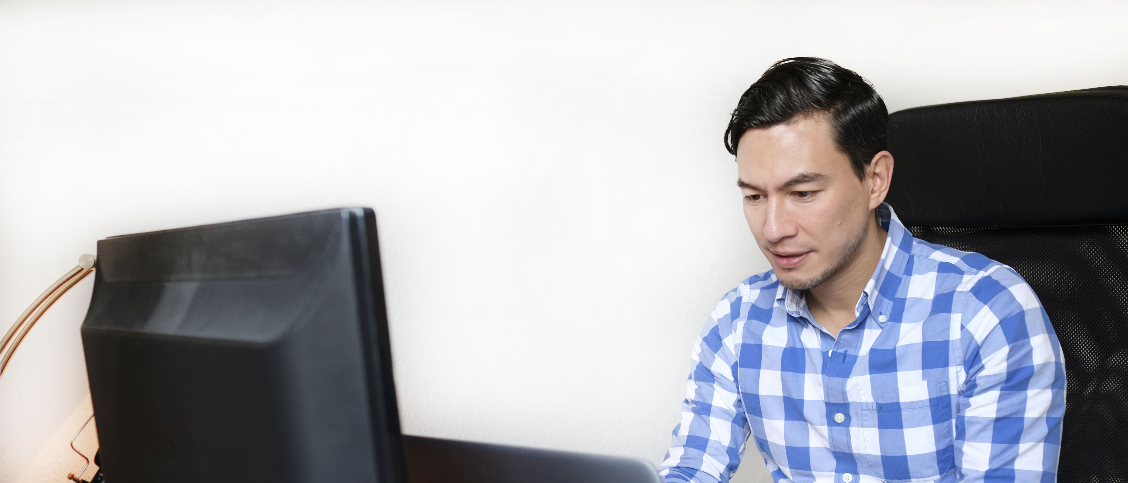 Man working with laptop at home.