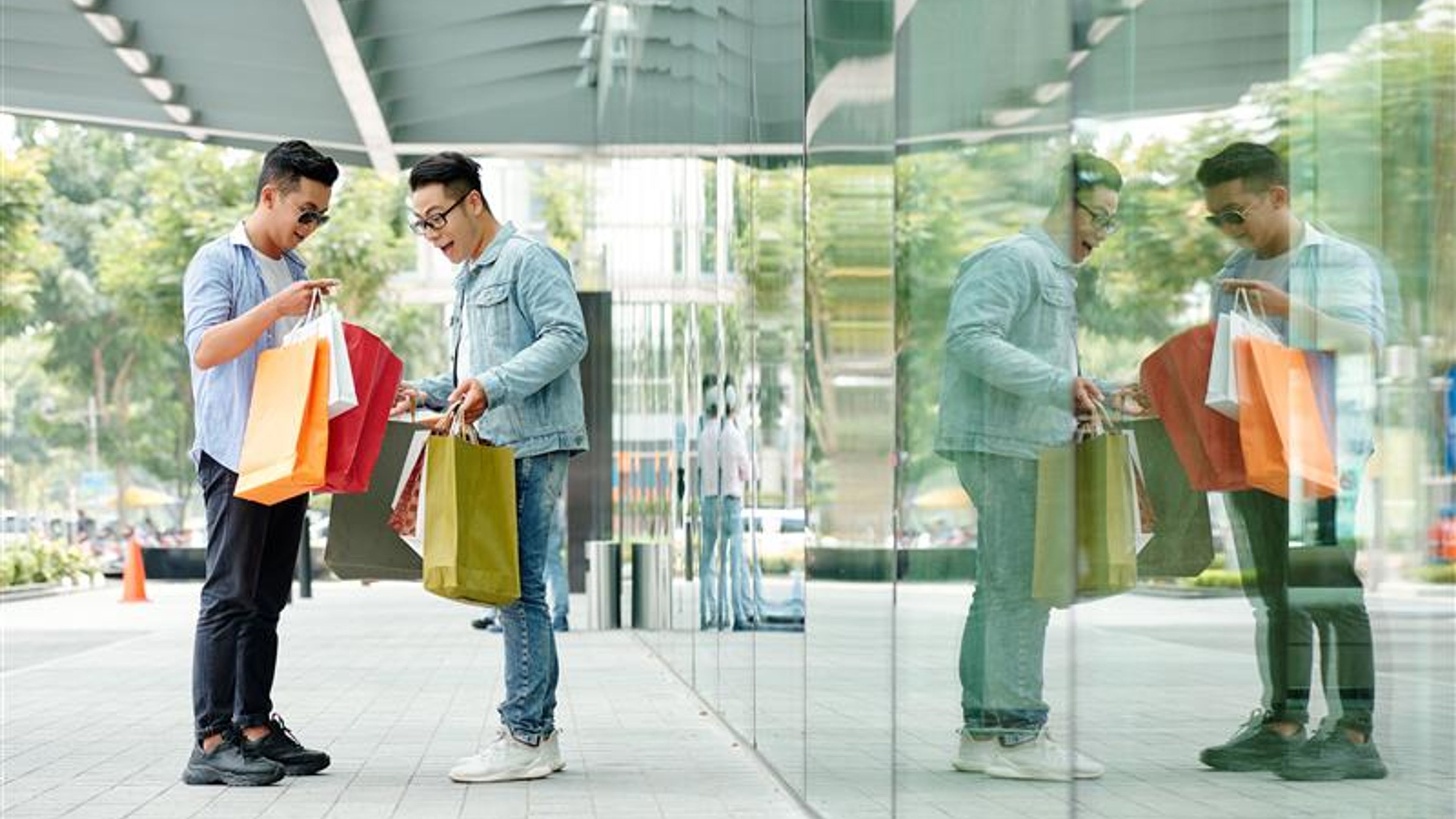 Men holding shopping bags.