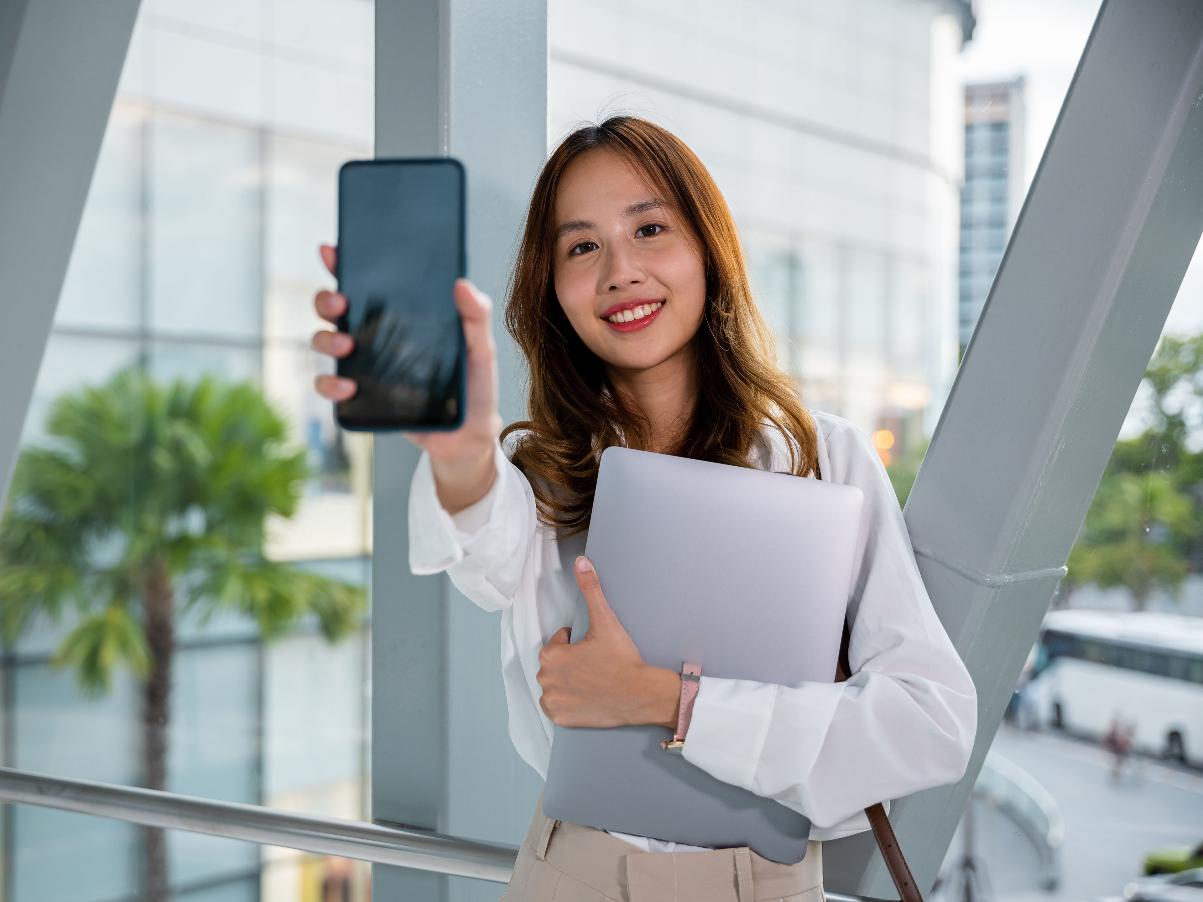 Professional woman uses her mobile phone in an airport