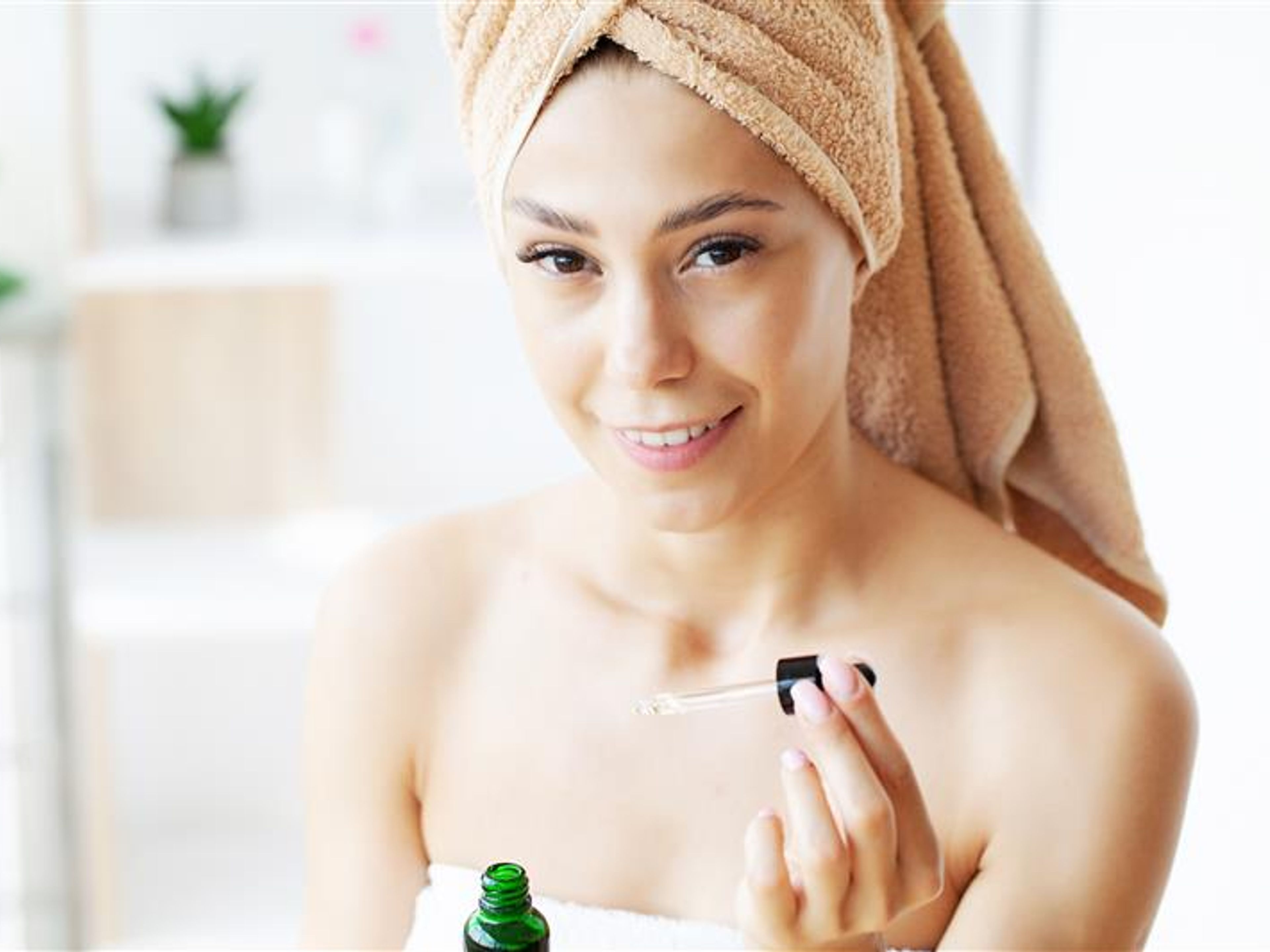 Woman with a drops of cream on her face