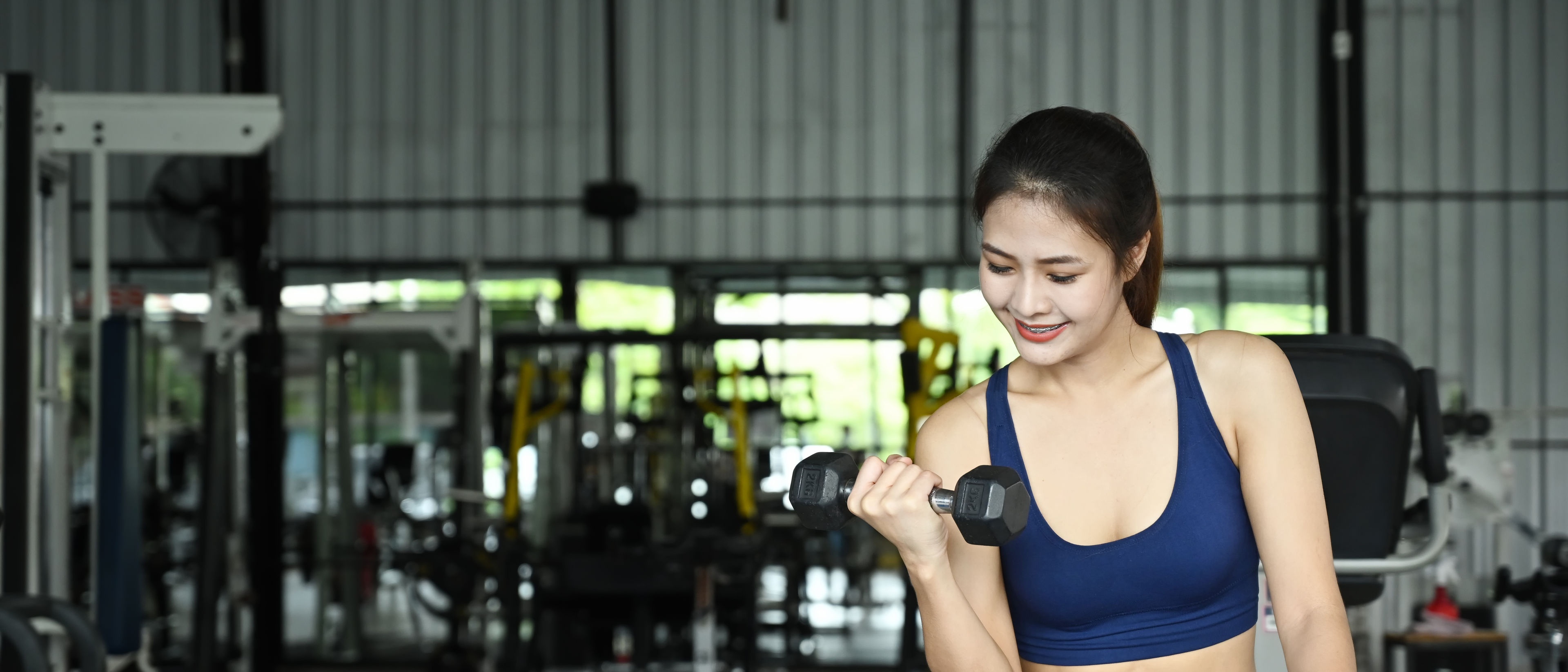 Woman working out with dumbells.